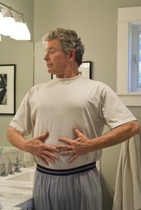 Man examining his physique in the mirror